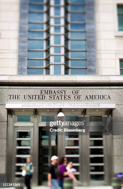 People pass in front of the U.S. Embassy in Ottawa, Ontario, Canada, on Tuesday, Aug. 9, 2011. Canada's trade deficit widened more than forecast in...