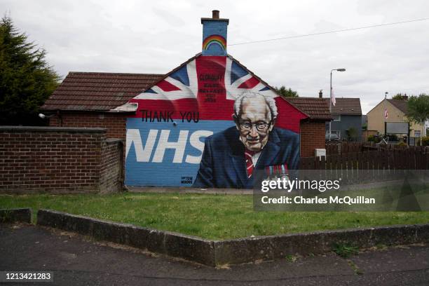 Mural depicting 100 year old army veteran and NHS fund raiser Captain Tom Moore can be seen in a loyalist housing estate on May 18, 2020 in Belfast,...