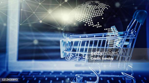 online shopping concept. closeup of shopping basket with digital globe and wireless digital line connection symbol on laptop. business and technology. - shopping online blue stock pictures, royalty-free photos & images