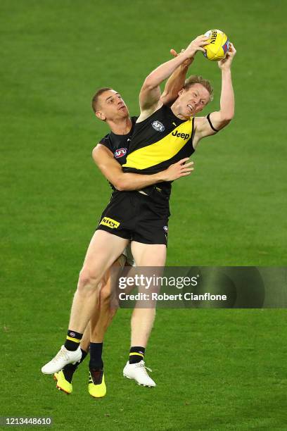 Jack Riewoldt of the Tigers and Liam Jones of the Blues compete for the ball during the round 1 AFL match between the Richmond Tigers and the Carlton...