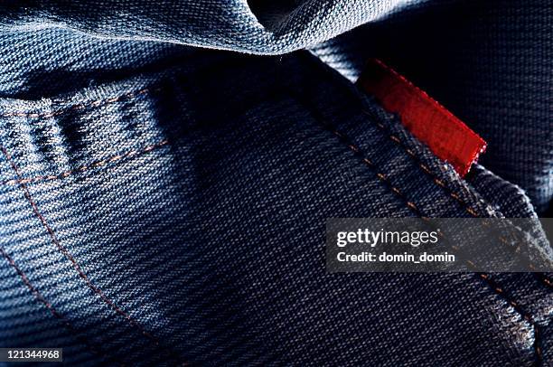 close-up of pocket in blue jeans with red label, studio - jeans label stock pictures, royalty-free photos & images