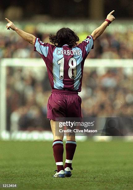 Benito Carbone of Aston Villa salutes his second goal during the AXA sponsored FA Cup Fifth Round match against Leeds United played at Villa Park in...
