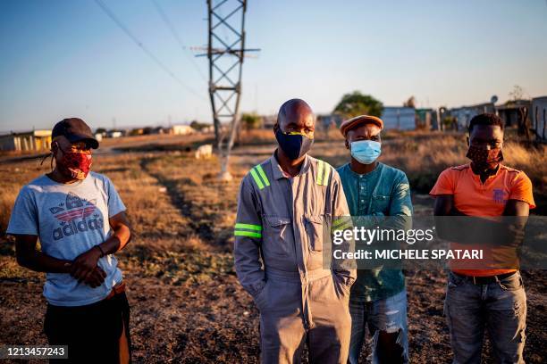 Miners gather in the Wonderkop settlement in Marikana, near Rustenburg, on May 15, 2020. - The mines are a critical cog in South Africa's already...