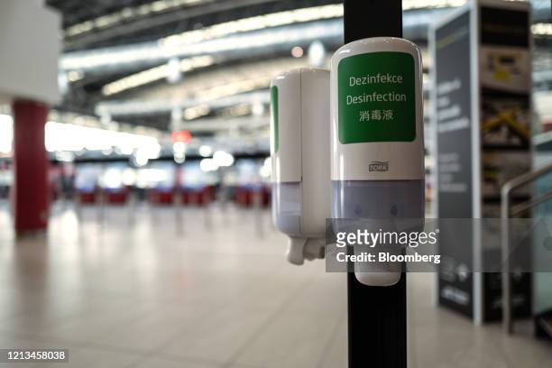 Disinfectant hand wash dispensers stand on a pole inside the terminal at Vaclav Havel Airport in Prague, Czech Republic, on Monday, May 18, 2020....