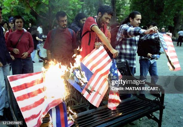 Youth burn US flag during a protest against the IDB in Santiago, Chile, 20 March 2001. Since the opening of the IDB meeting in the capital anti IDB...