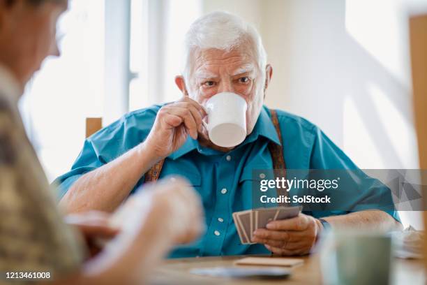 always time for tea - senior men playing cards stock pictures, royalty-free photos & images