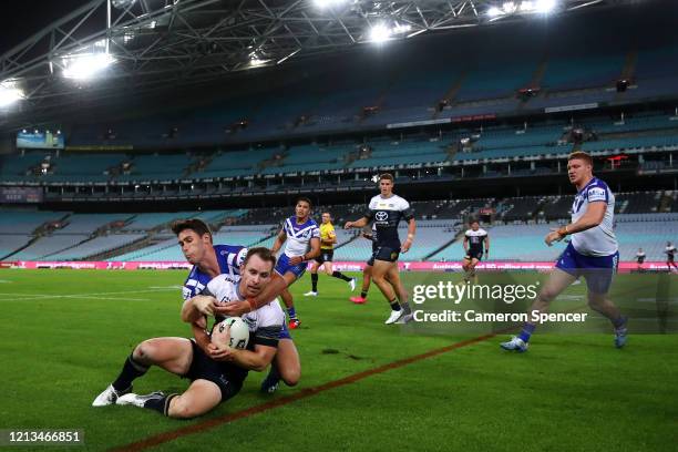 Michael Morgan of the Cowboys is tackled by Nick Meaney of the Bulldogs during the round 2 NRL match between the Canterbury Bulldogs and the North...