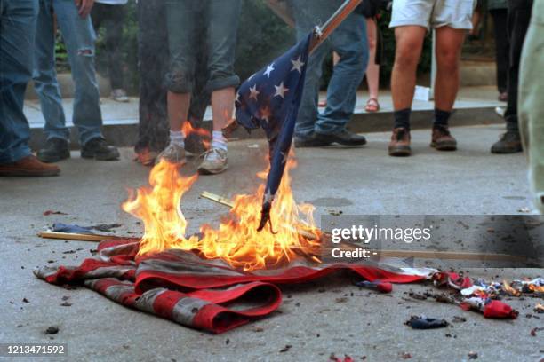 This 20 April 2002 file photo shows demonstrators burning US flags in front of the World Bank headquarters during a protest against the International...