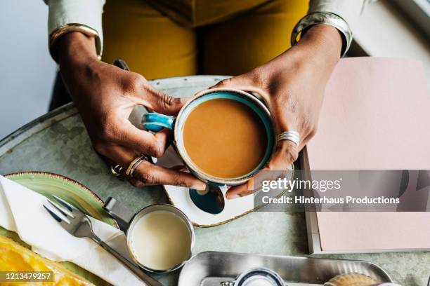 aerial view of woman drinking coffee - black mug stock pictures, royalty-free photos & images