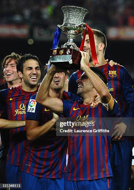 Xavi and Cesc Fabregas of Barcelona celebrate with the trophy after victory in the Super Cup second leg match between Barcelona and Real Madrid at...