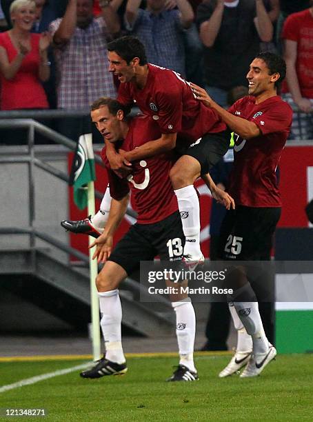 Jan Schlaudraff of Hannover celebrates after he scores his team's opening goal during the UEFA Europa League play-off match between Hannover 96 FC...