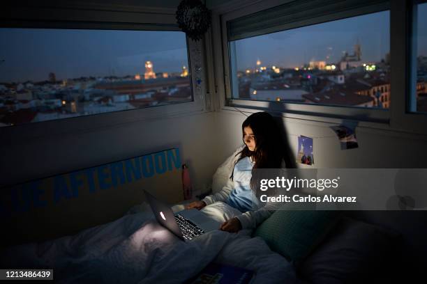 In this photo illustration, a teenage girl watches a series on the bed in her room on March 18, 2020 in Madrid, Spain. As part of the measures...