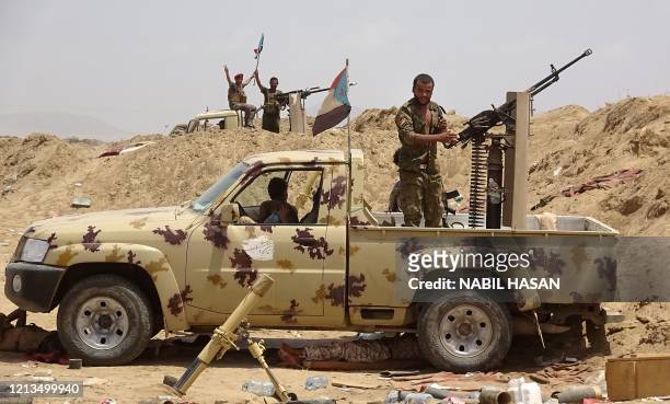 Fighters loyal to Yemen's separatist Southern Transitional Council stand guard in the Sheikh Salim area in the southern Abyan province on May 18...