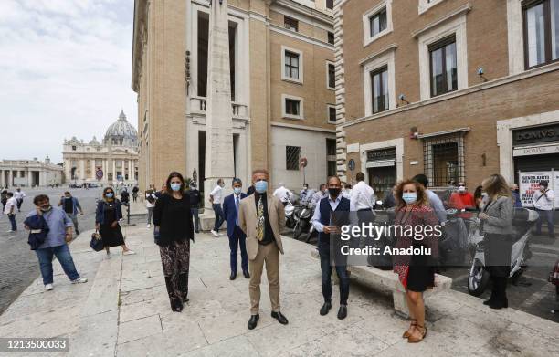 Representatives of merchant associations protest by complaining insufficient state aid near St. Peter's Square at the Vatican in Rome, Italy, on May...