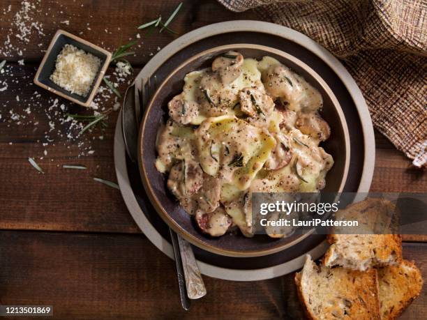 cheese ravioli with sausage and mushrooms in a  rosemary cream sauce - bechamel sauce stock pictures, royalty-free photos & images