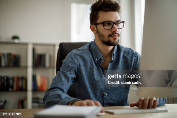 young man working at the office - students working on pc school stock pictures, royalty-free photos & images