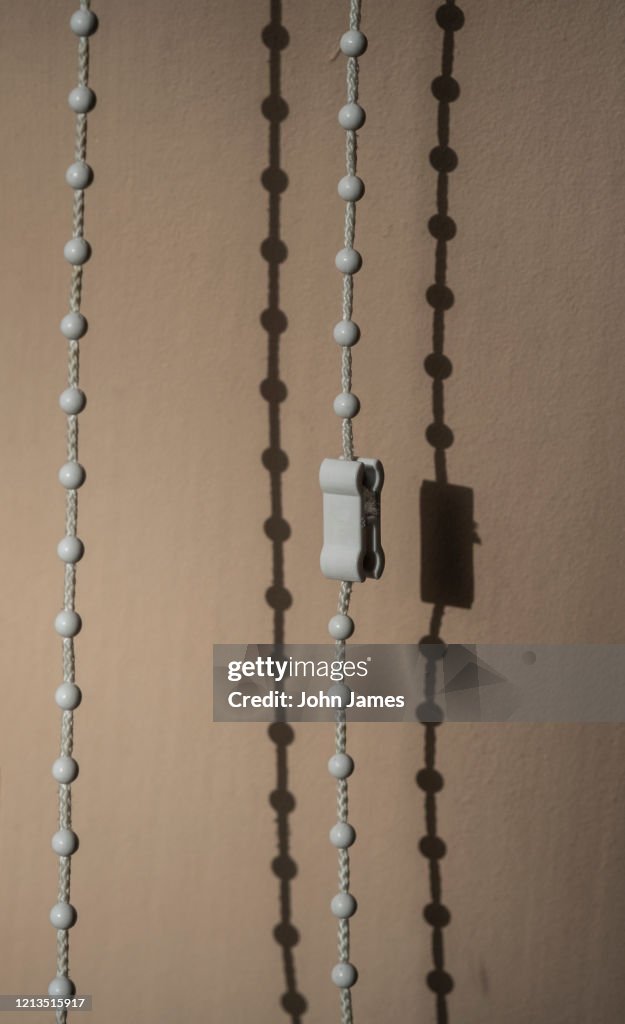 Shadows of a roller blind pull cord