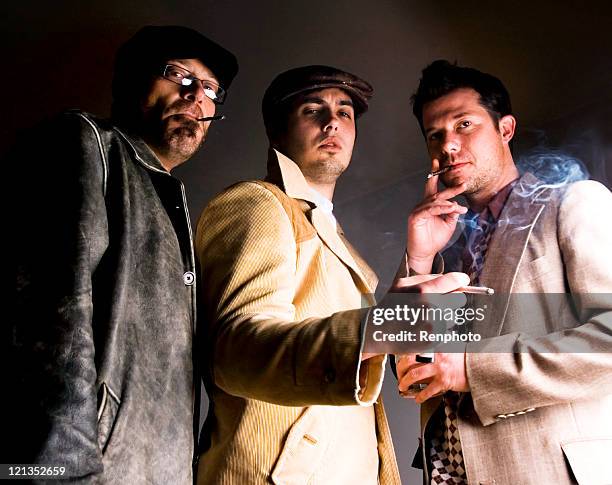 three men standing around smoking cigarettes - hooligan stock pictures, royalty-free photos & images