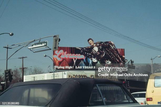 Sign above the David George interiors store on Melrose Avenue, Los Angeles, advertises an appearance by pianist Liberace at the Las Vegas Hilton,...