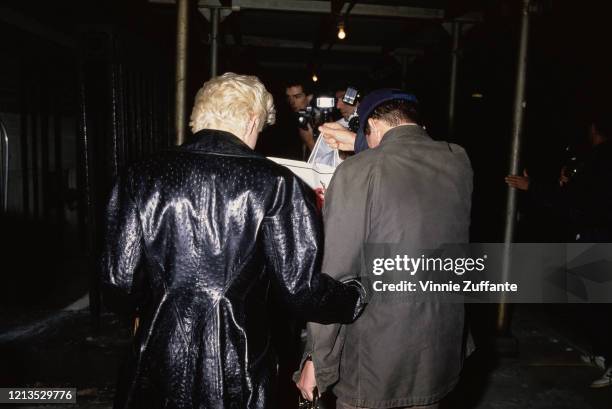 American singer Madonna leaves a theatre with her husband, actor Sean Penn, circa 1988.