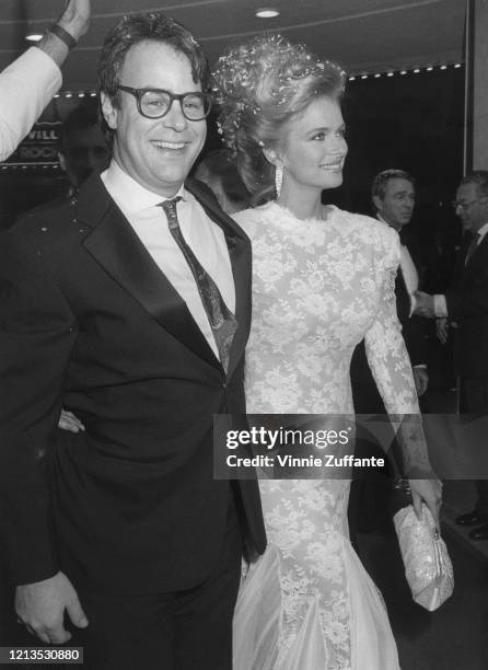 Canadian actor and comedian Dan Aykroyd and his wife, actress Donna Dixon arrive at the opening of the film 'Spies Like Us' in New York City, 1985....