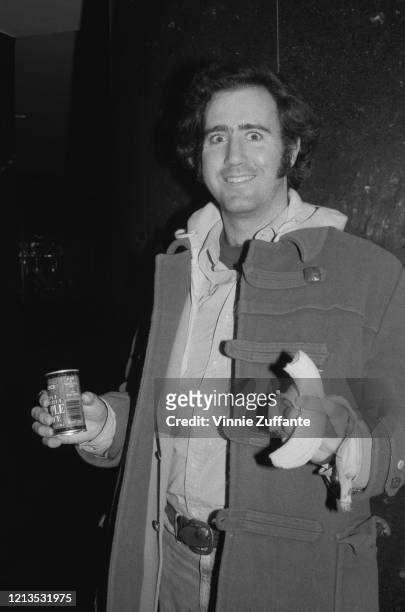 American actor and entertainer Andy Kaufman , eating a banana and drinking a can of Seneca apple juice, circa 1980.