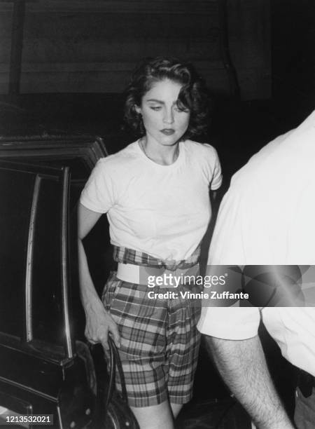 American singer and actress Madonna wearing tartan shorts, circa 1988.