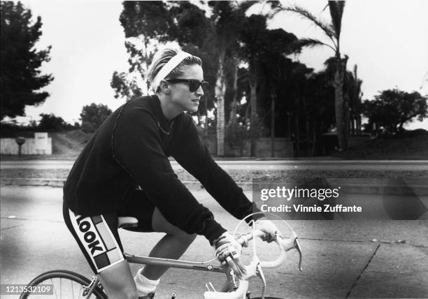 American singer and actress Madonna out cycling, circa 1985.