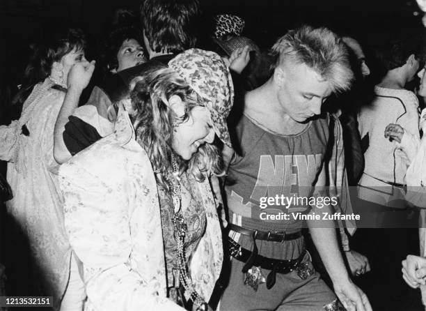 American singer Madonna and British singer Marilyn celebrate Boy George's birthday at the Palladium nightclub in New York City, 1985.