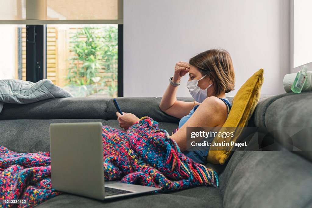 Woman self isolating on the sofa with flu