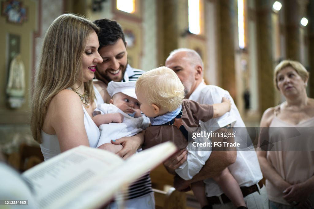 Parents and his son on baptism celebration at church