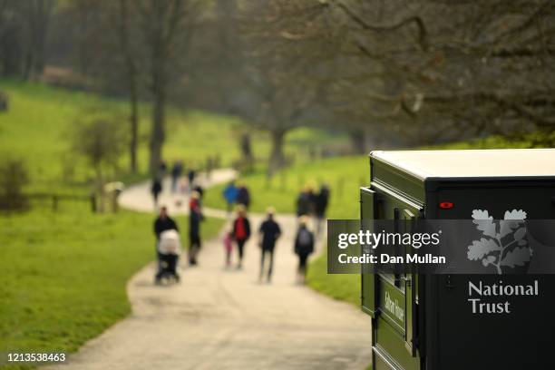 Members of the public enjoy a walk at Saltram House after the National Trust announced that they will not be charging an entry fee at their sites in...