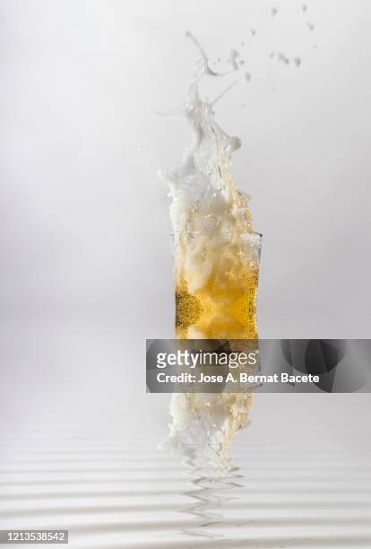 full beer glass that falls on the floor. - overflowing beer stock pictures, royalty-free photos & images
