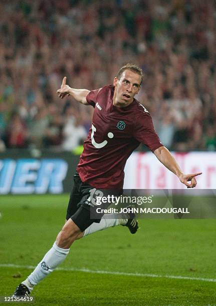 Hanover's striker Jan Schlaudraff celebrates after scoring his second goal during the UEFA Europa League play off match Hanover 96 vs FC Sevilla in...