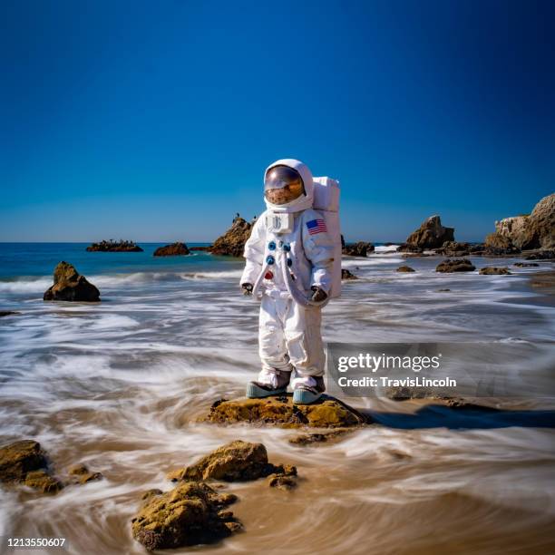 spaceman in the surf - malibu beach stock pictures, royalty-free photos & images