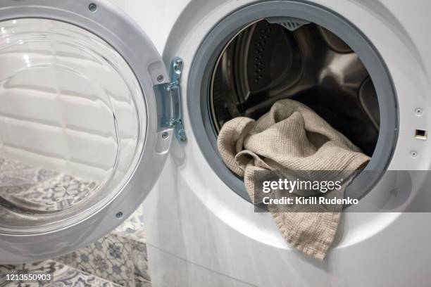 towel hanging out of a washing machine - secador de roupas imagens e fotografias de stock