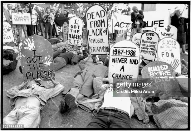 Protesters close the Federal Drug Administration building to demand the release of experimental medication for those living with HIV/AIDS. Their...