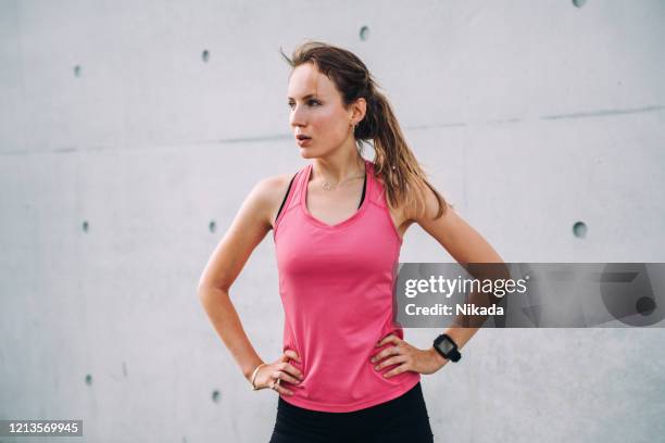 young sporty woman in modern business district - tracksuit stock pictures, royalty-free photos & images