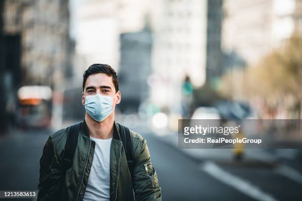 portrait of man with mask on the street. - mask man stock pictures, royalty-free photos & images