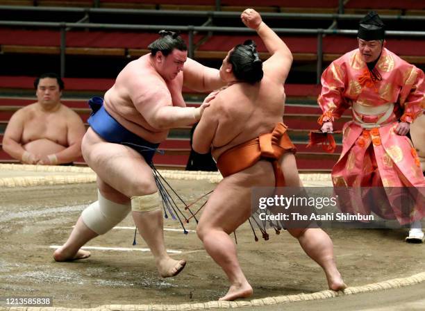 Bulgarian wrestler Aoiyama pushes Mitakeumi out of the ring to win on day twelve of the Grand Sumo Spring Tournament at Edion Arena Osaka on March...