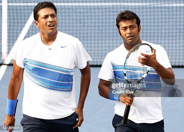 The doubles team of Mahesh Bhupathi and Leander Paes of India talk in between games of their match against Marc Lopez and Rafael Nadal of Spain...