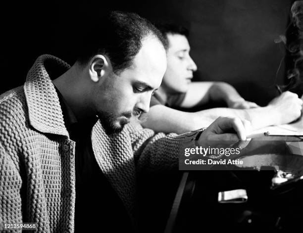 Songwriters and producers Jerry Leiber and Mike Stoller compose a song during a photo shoot for Vogue Magazine in Stoller's apartment in 1959 in New...