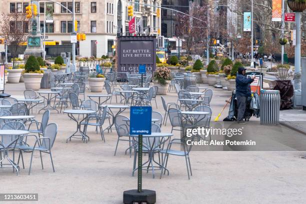 the single sanitation worker cleaning flatiron public plaza deserted during the coronavirus outbreak. - flatiron district stock pictures, royalty-free photos & images