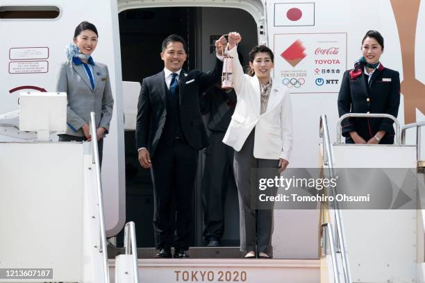 Olympic gold medalists Tadahiro Nomura and Saori Yoshida hold the Olympic flame during the Tokyo 2020 Olympic Games Flame Arrival Ceremony at the...