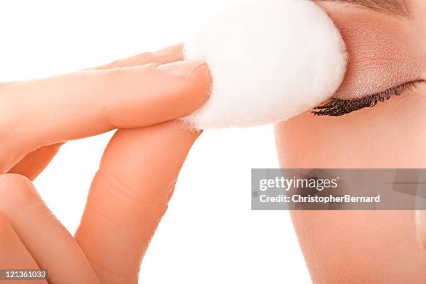 close-up female using cotton ball on her eye - woman applying cotton ball stock pictures, royalty-free photos & images