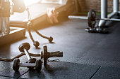 Gym background Fitness weight equipment on empty dark floor