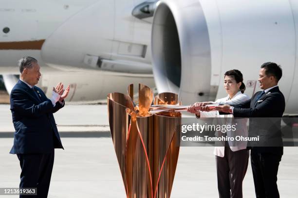 Tokyo Olympic and Paralympic Organizing Committee President Yoshiro Mori claps on as Olympic gold medalists Tadahiro Nomura and Saori Yoshida light...