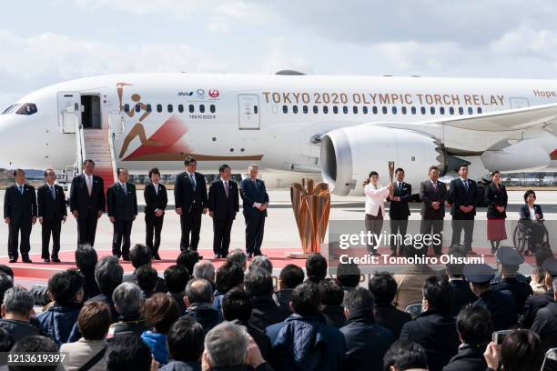 Olympic gold medalists Tadahiro Nomura and Saori Yoshida hold the Olympic torch as other representatives including Tokyo Olympic and Paralympic...