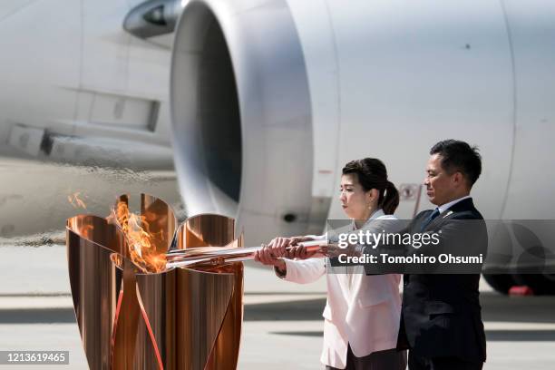 Olympic gold medalists Tadahiro Nomura and Saori Yoshida light the Olympic flame during the Tokyo 2020 Olympic Games Flame Arrival Ceremony at the...