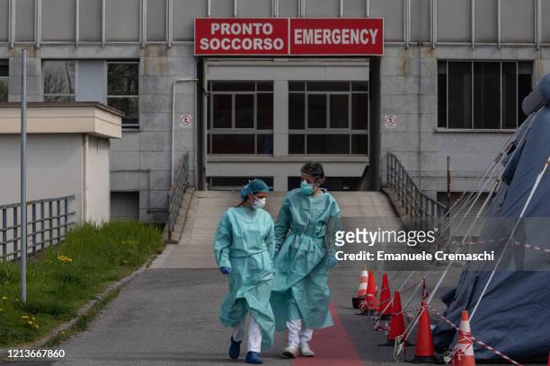 Two nurses walk in front of the Emergency Room of the local hospital on March 20, 2020 in Cremona, near Milan, Italy. The Italian government...